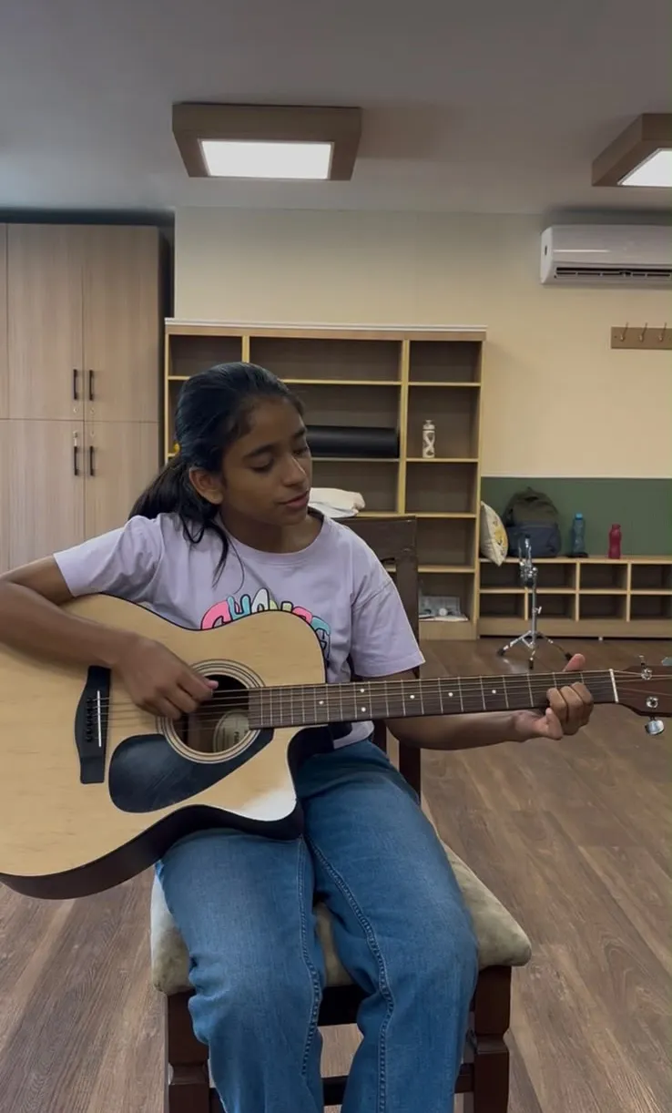 Student playing guitar at Brij School of Music